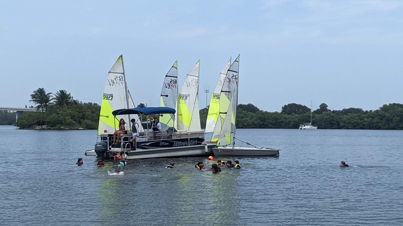 Boats anchored and children swimming in the lagoon