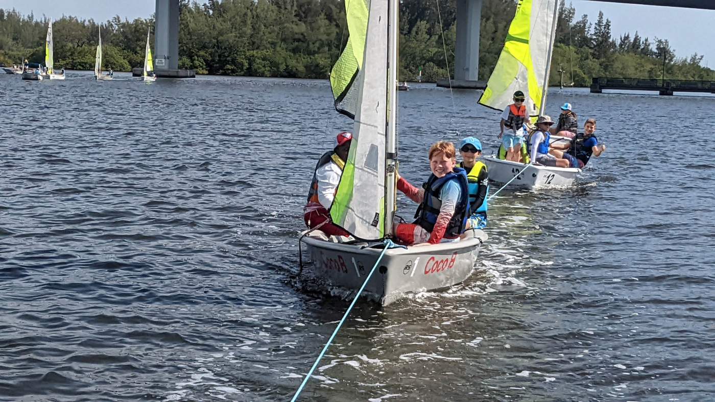 A sailboat being towed