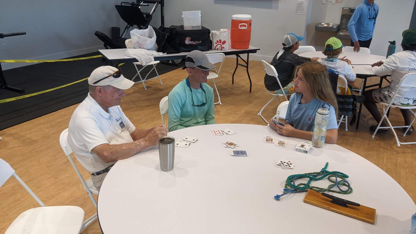 People seated around tables playing cards