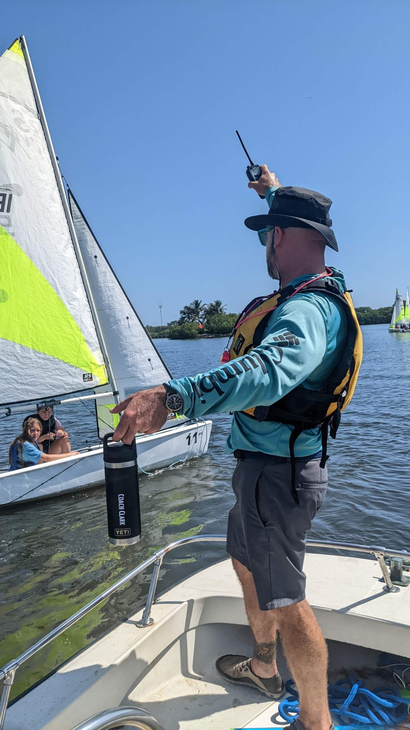 Children on a sailboat receiving instructions