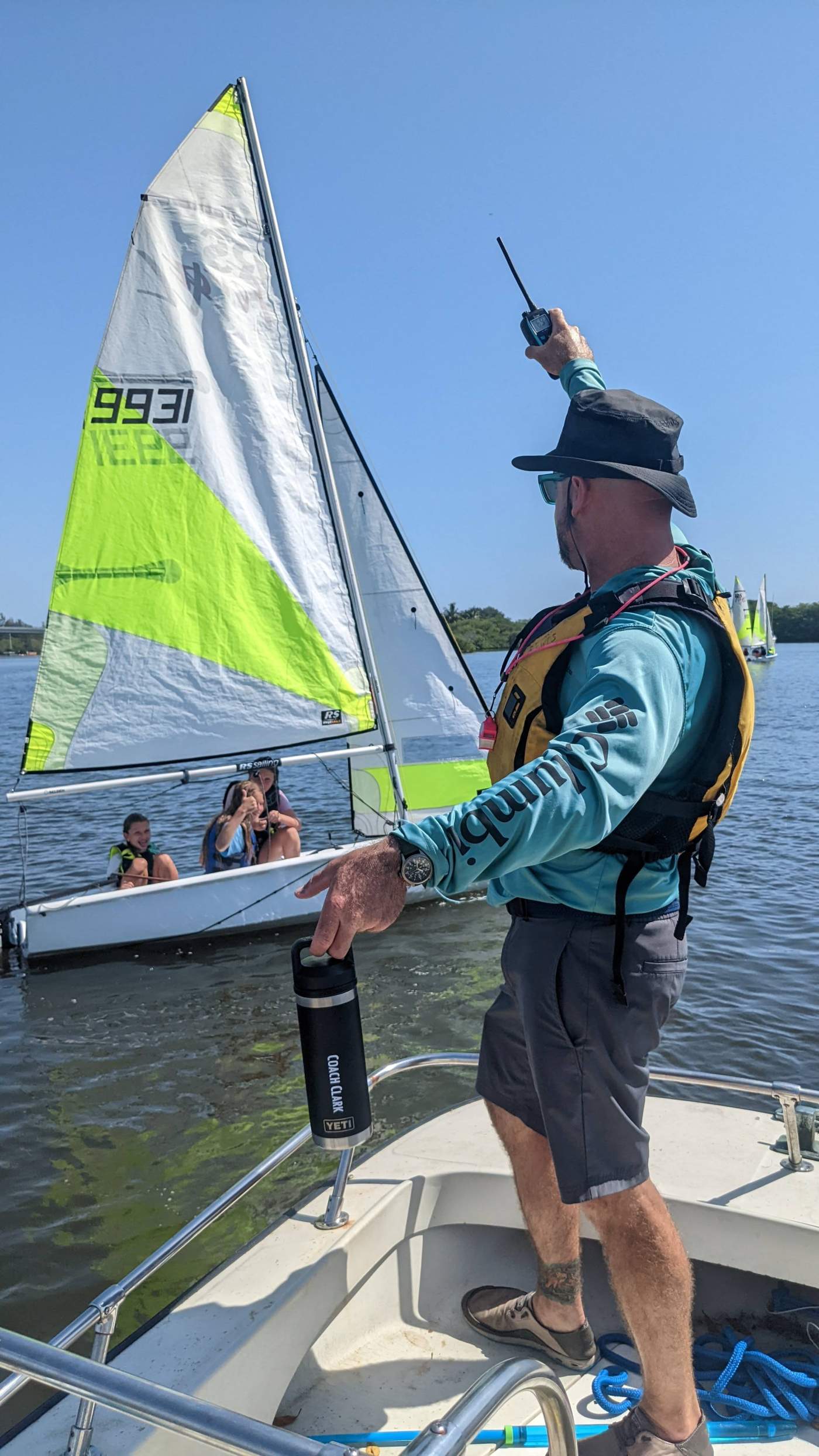 Children on a sailboat receiving instructions