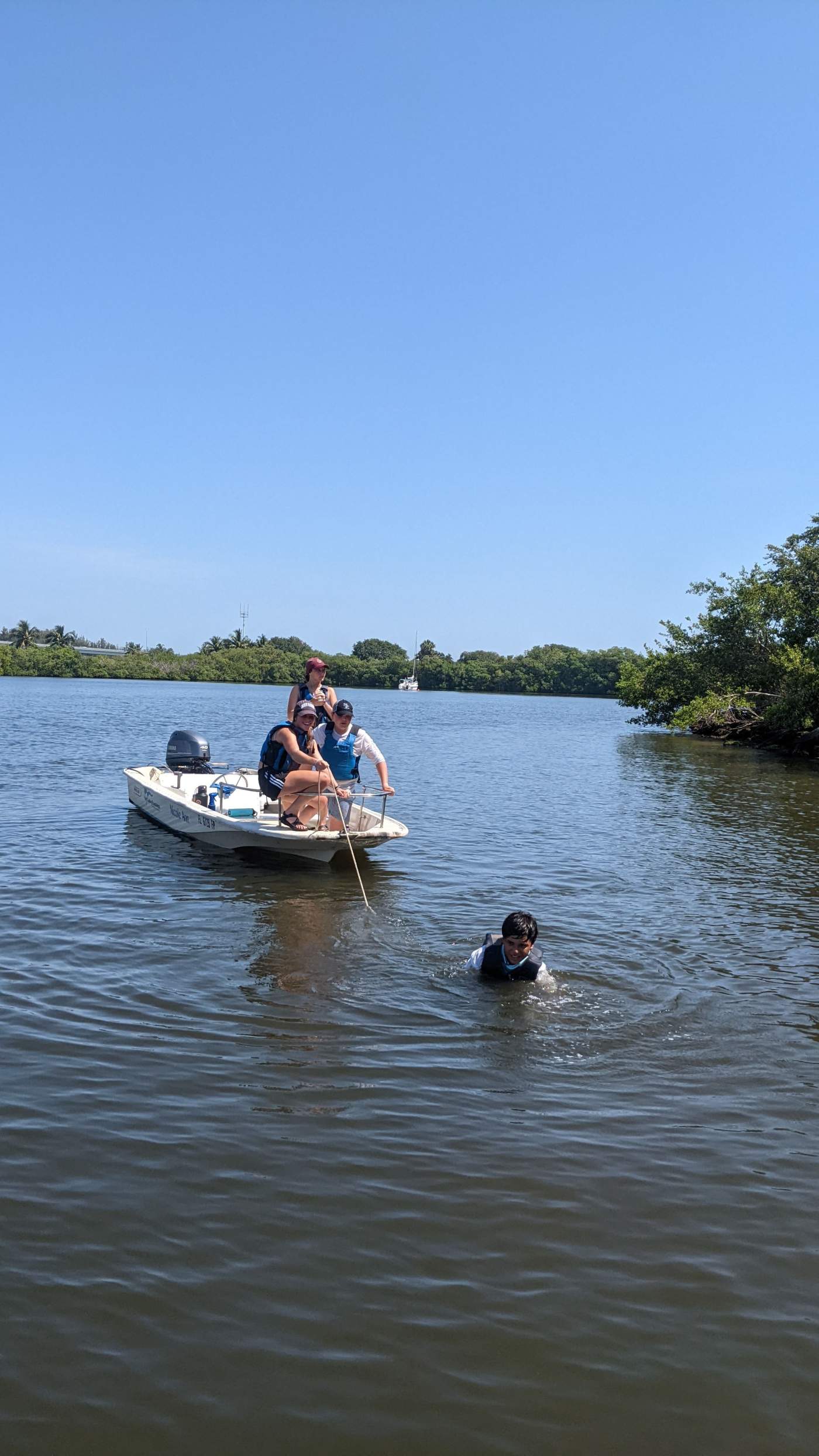 A power boat being pulled by a child in the water