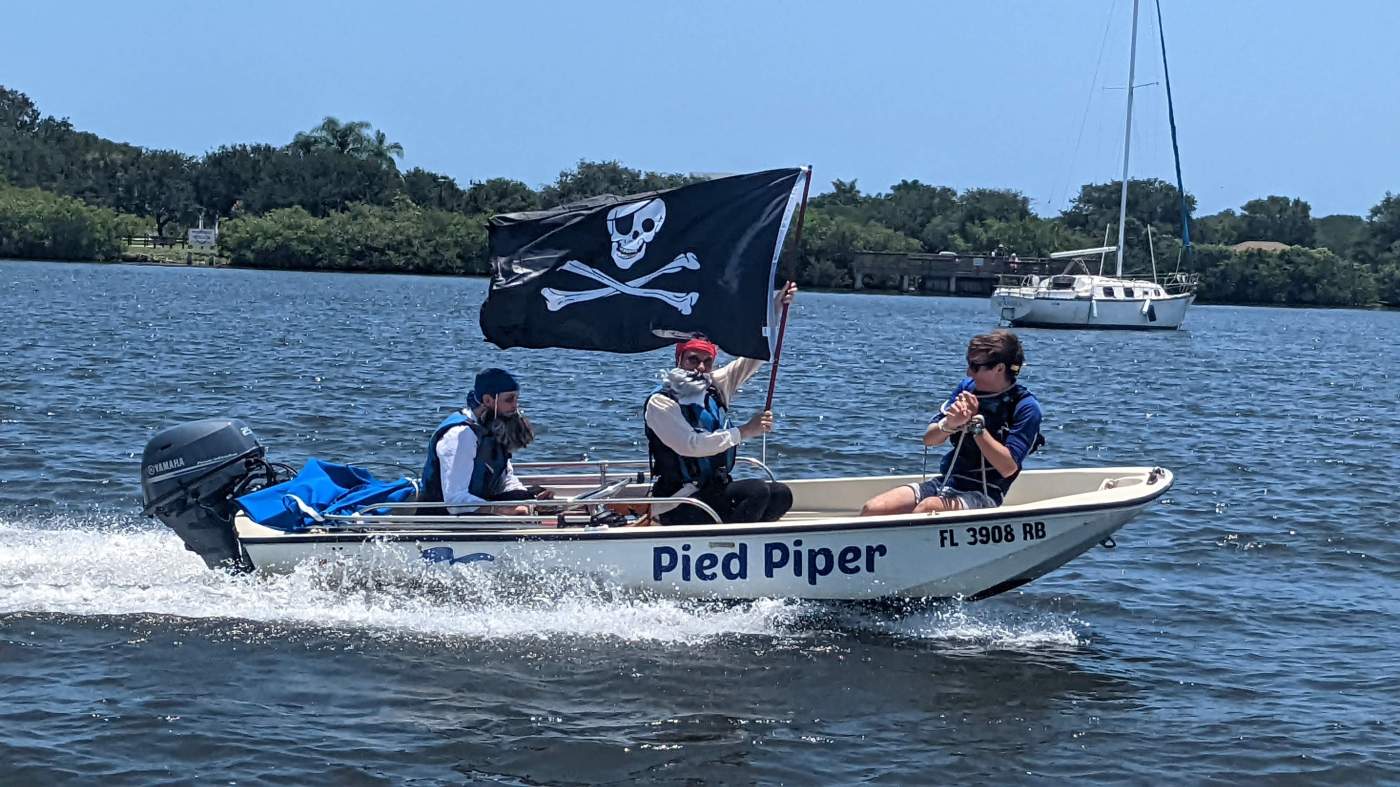 A powerboat with a pirate flag
