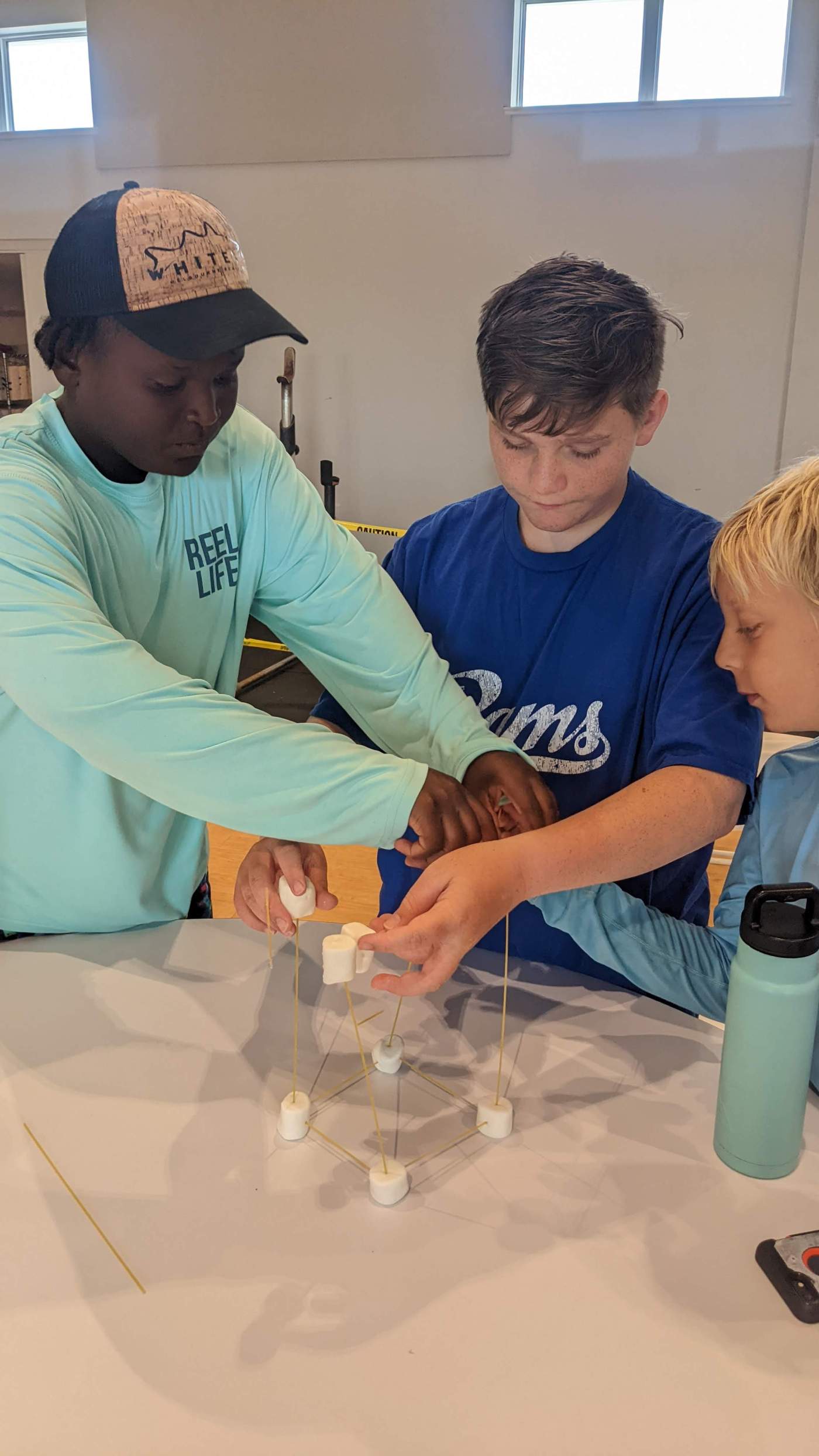 Boys standing around a table