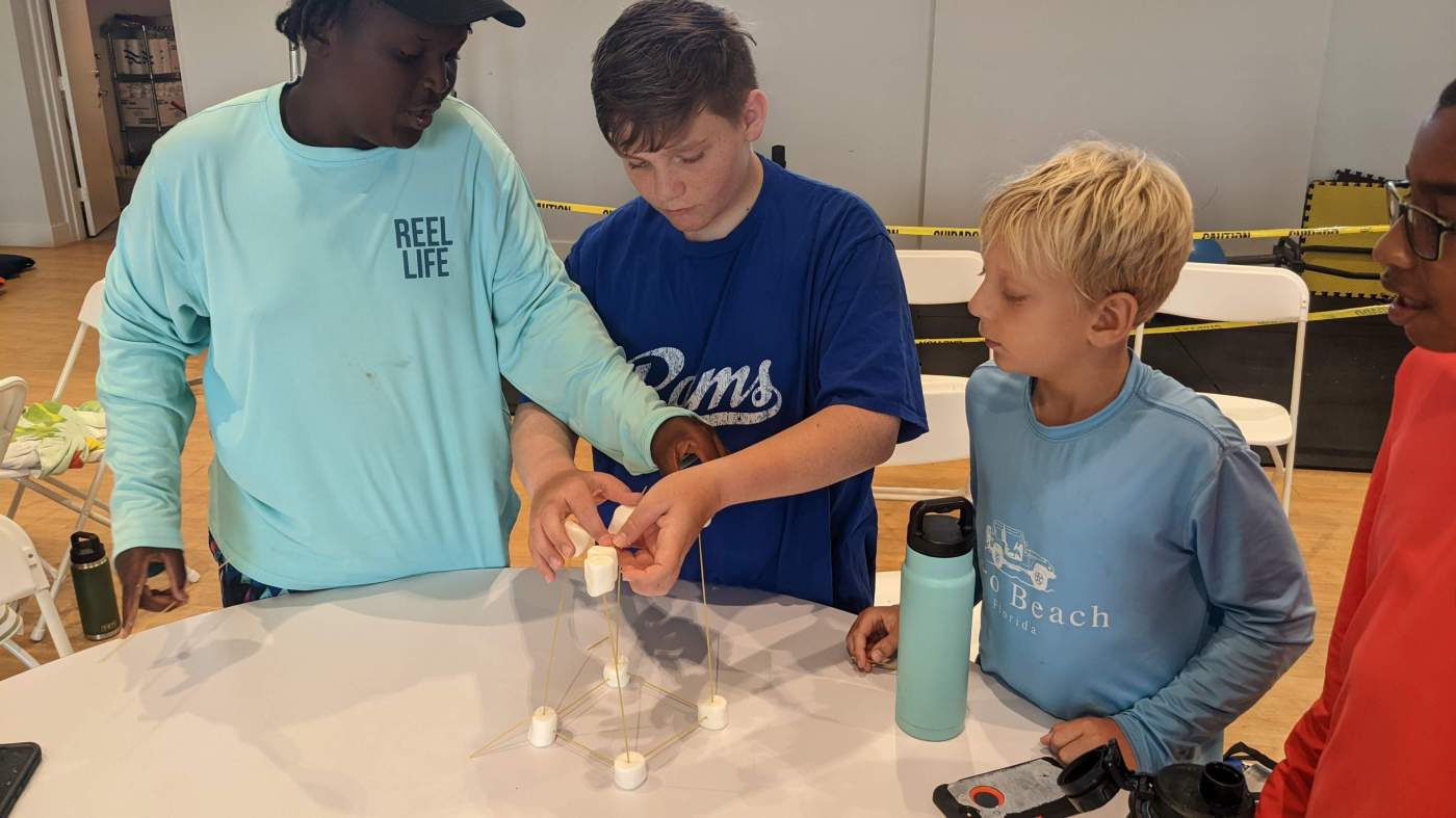 Boys standing around a table