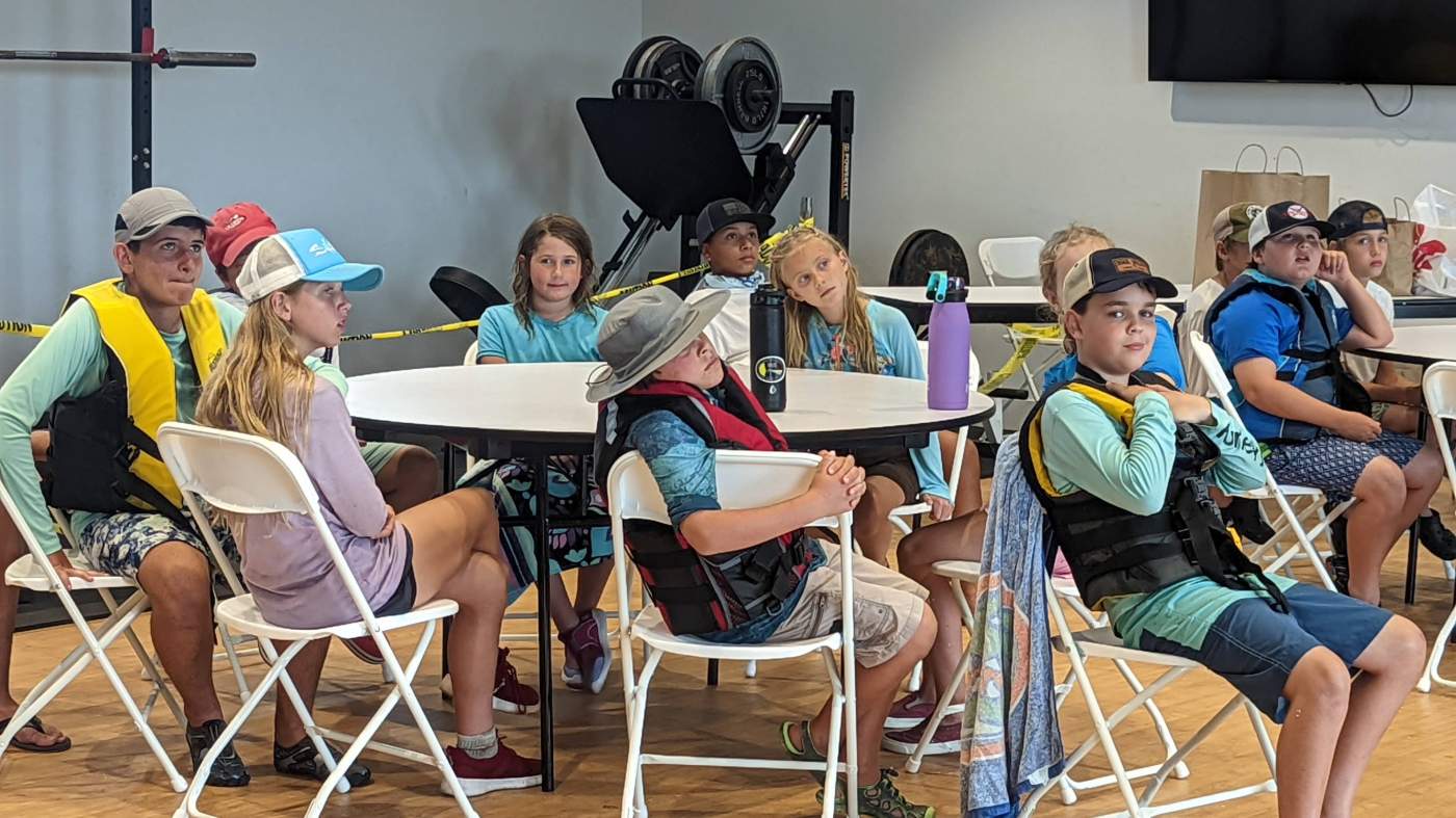 A group of children around a tables