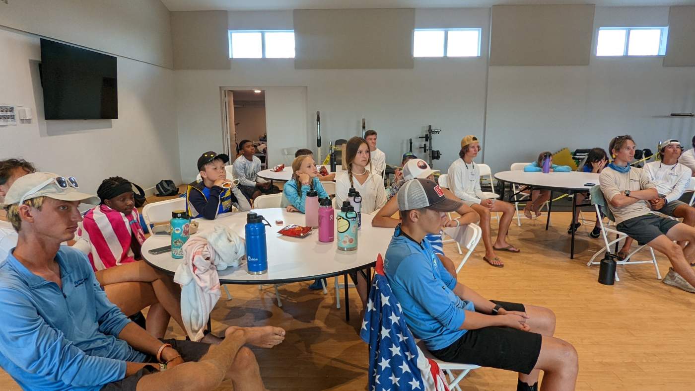 Children seated around a table listening to their instructor