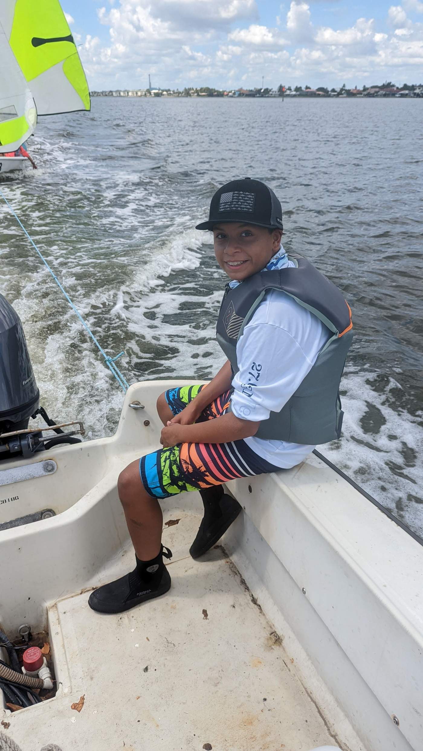 A boy sailing a boat