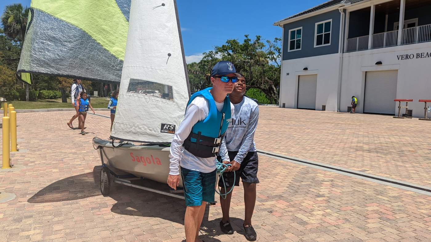 Two people pulling a boat