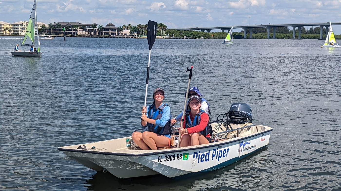 Three people in a powerboat