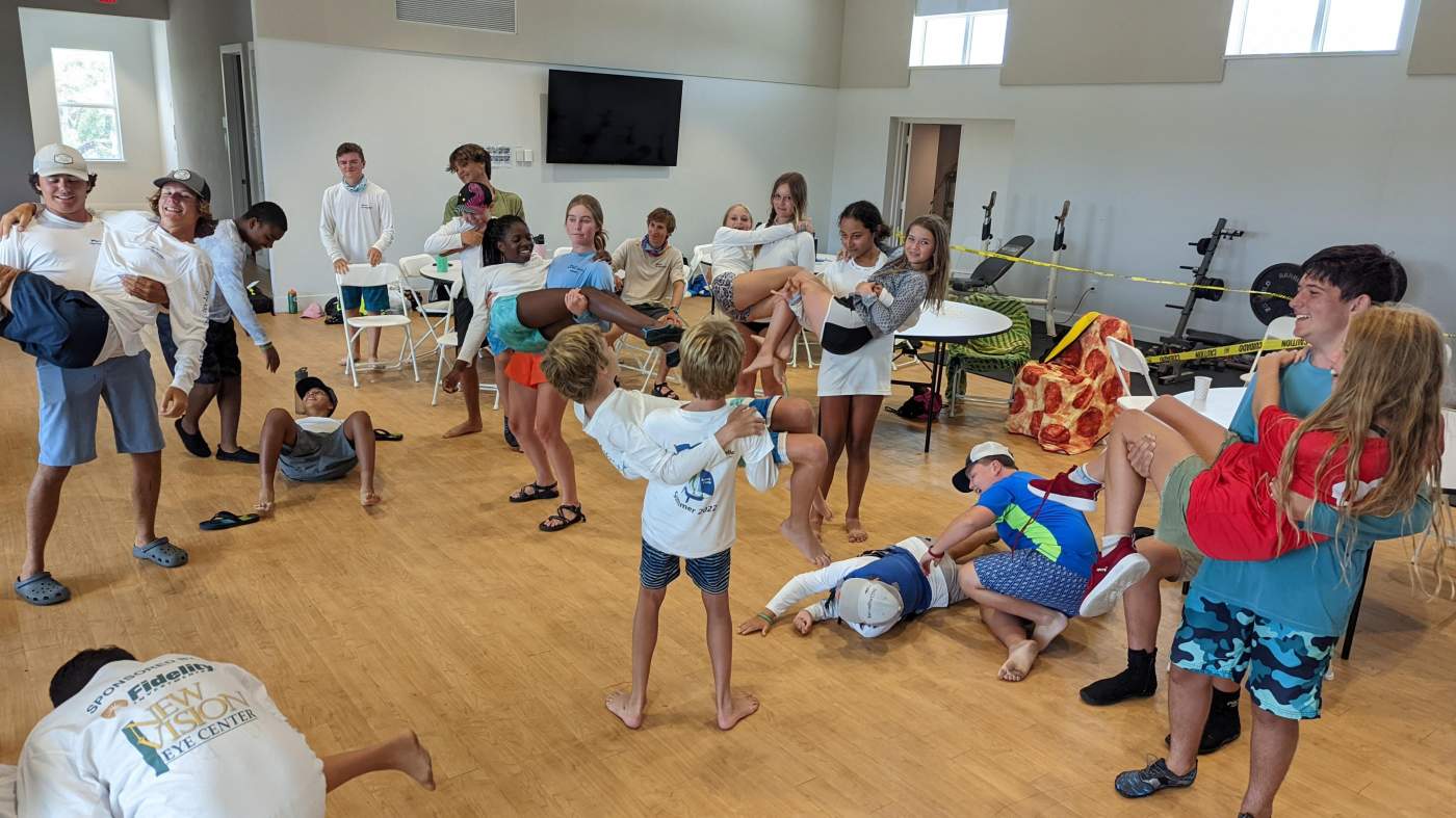 A group of children carrying other children
