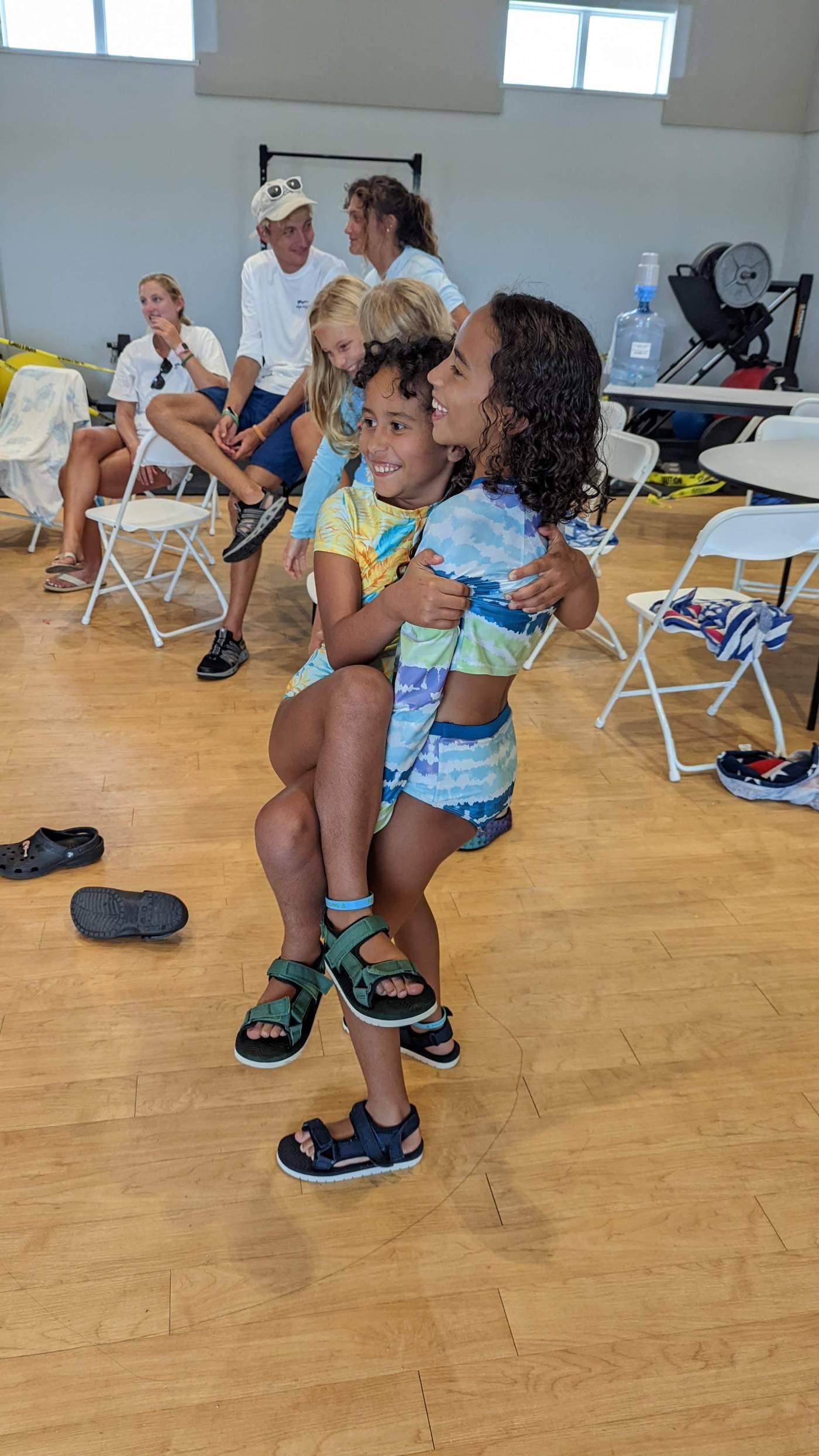 A group of children carrying other children piggyback