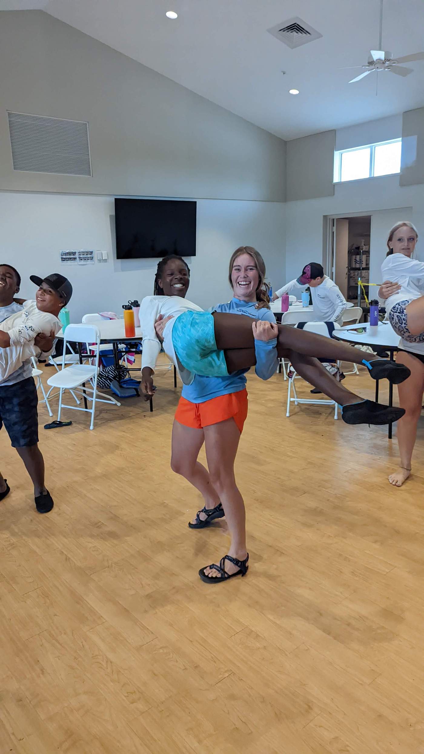 A group of children carrying other children