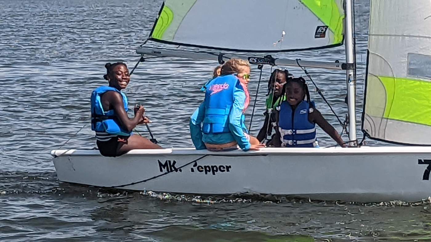 Five girls sailing a boat