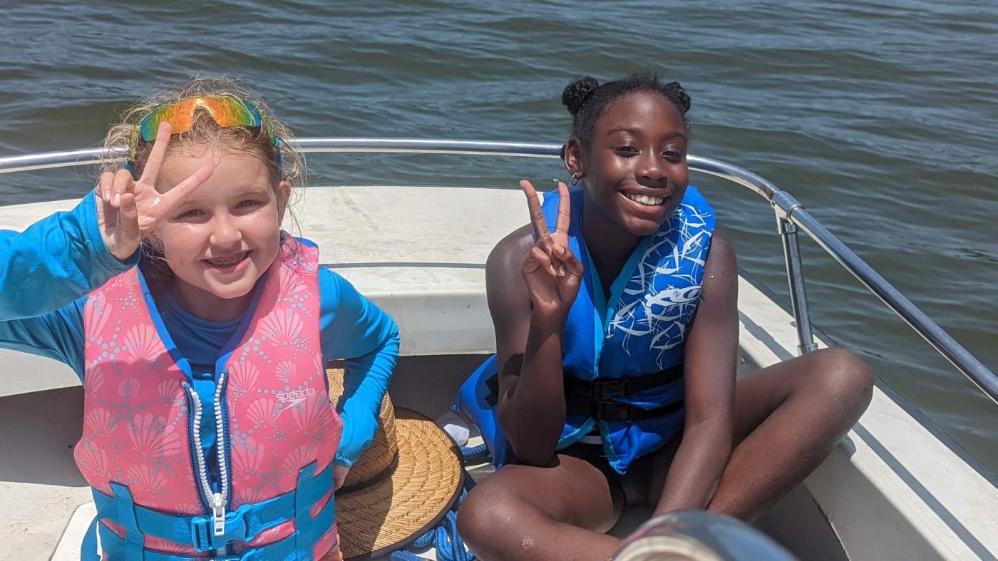 Two girls sailing a boat