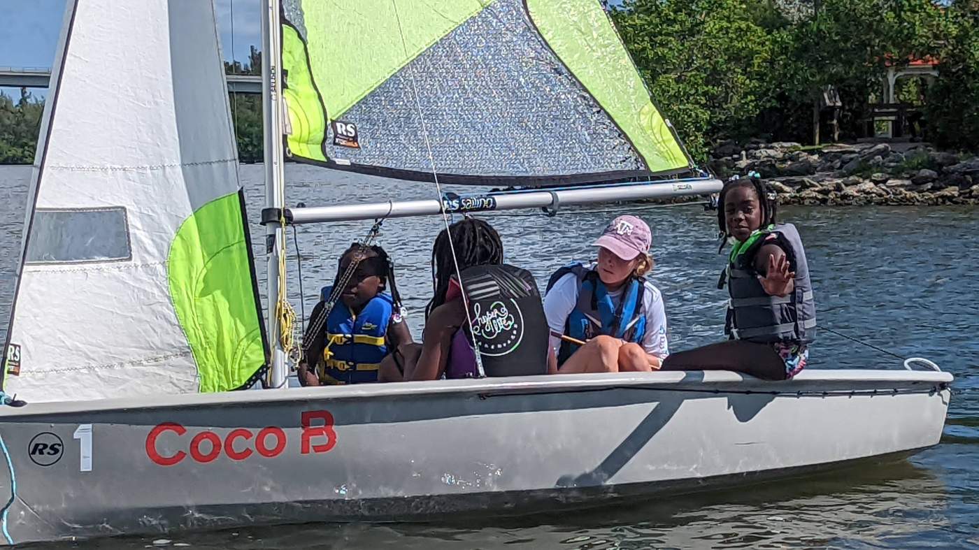 Four girls sailing a boat