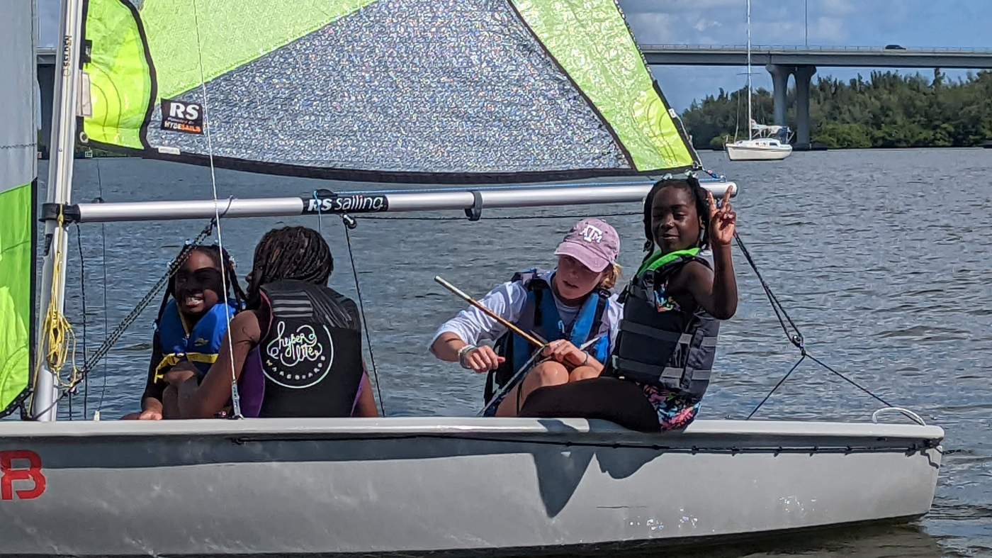 Four girls sailing a boat