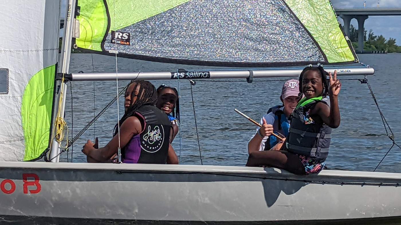 Four girls sailing a boat