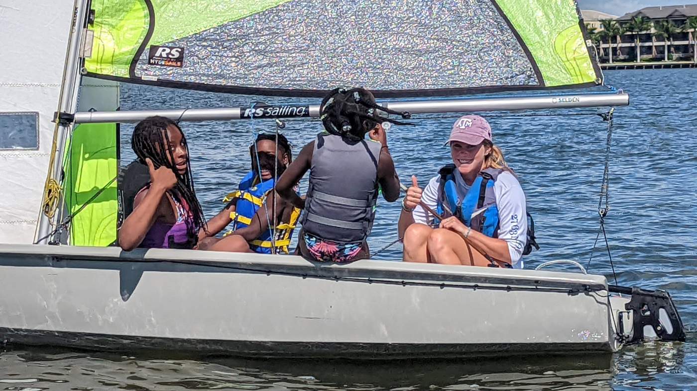 Four girls sailing a boat