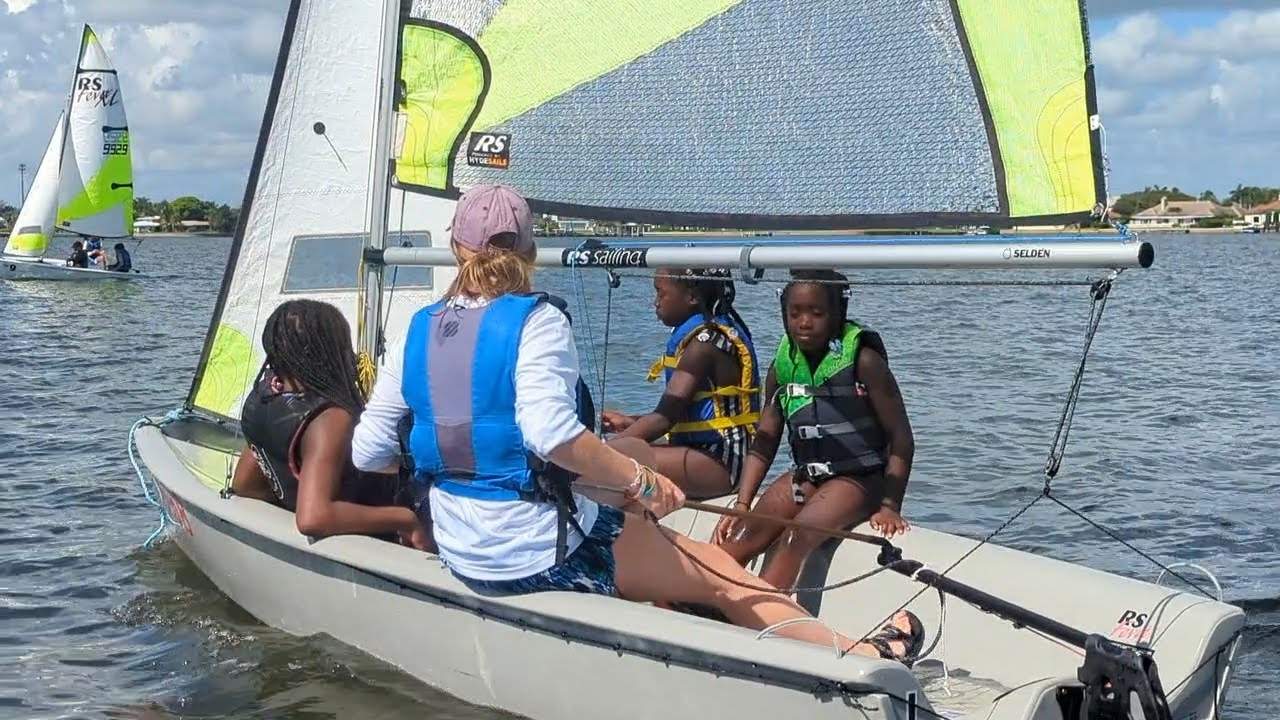 Four girls sailing a boat
