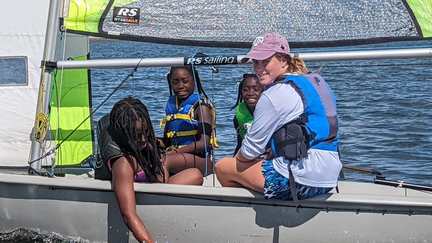 Four girls sailing a boat