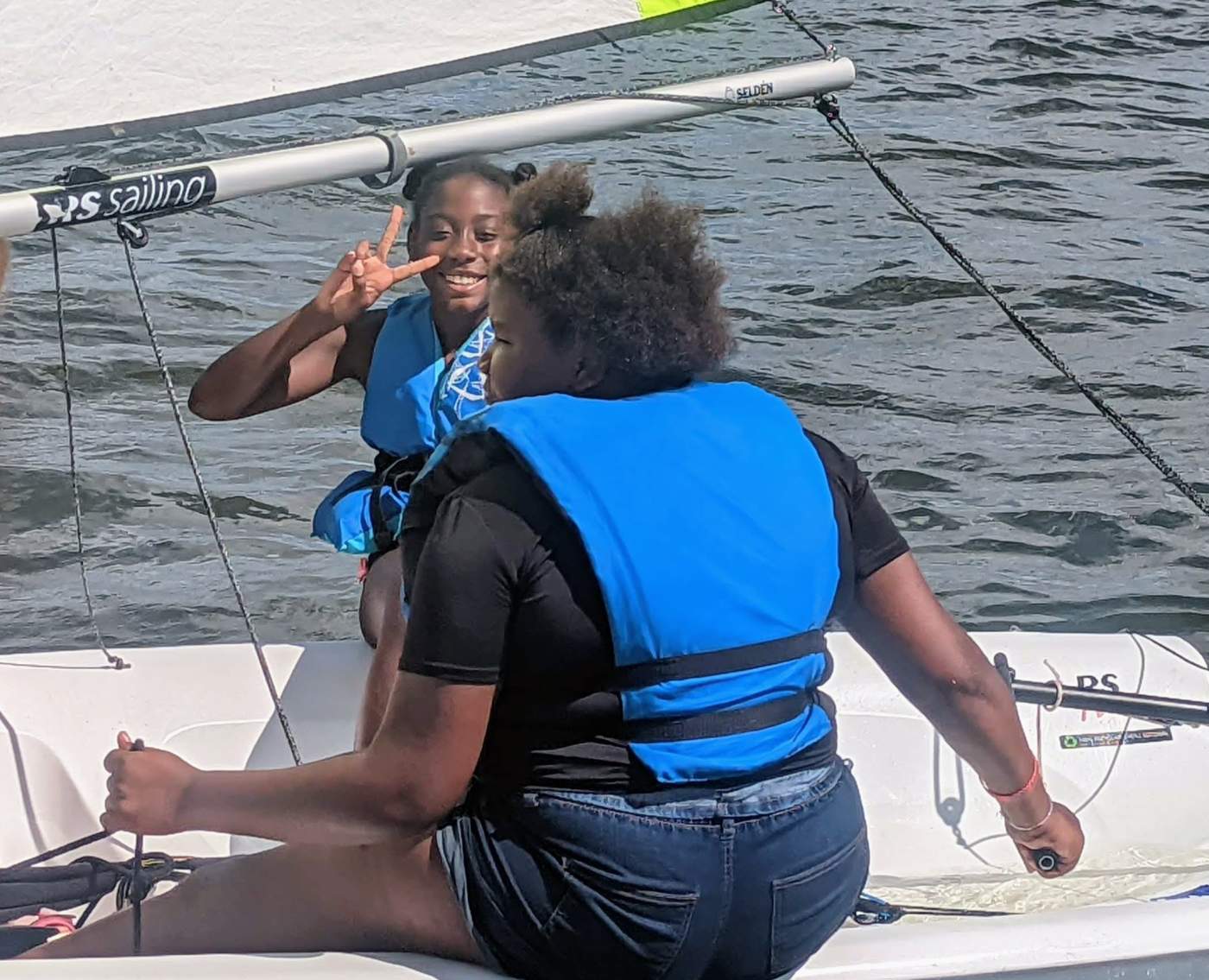 Two girls sailing a boat