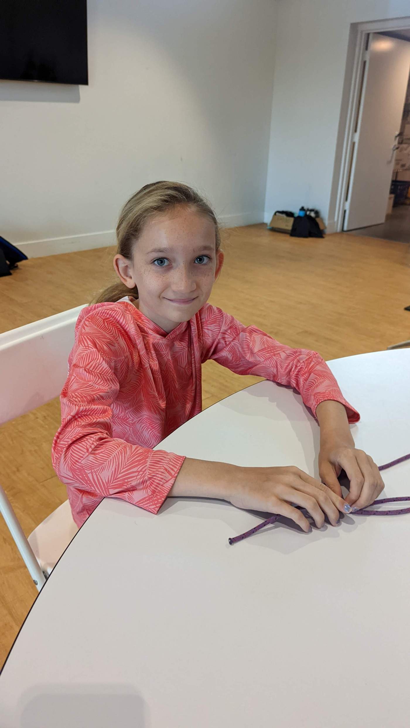 A young lady seated at a table