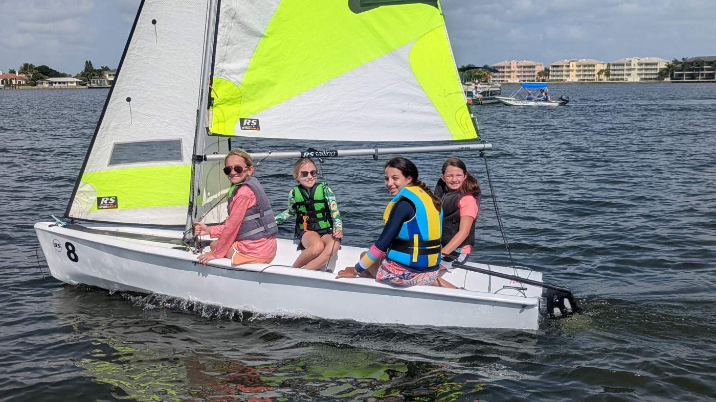 Four girls sailing a boat