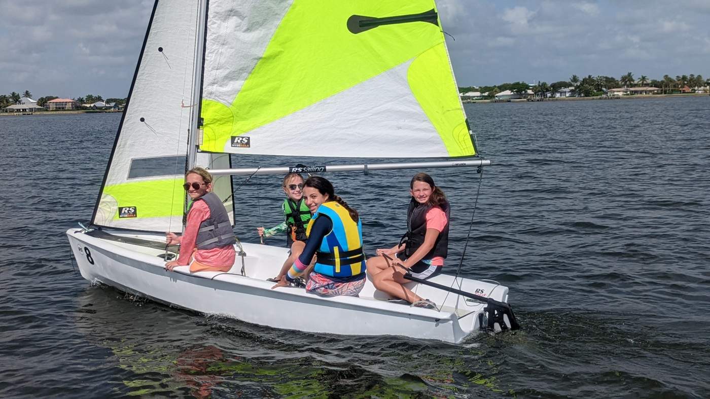 Four girls sailing a boat