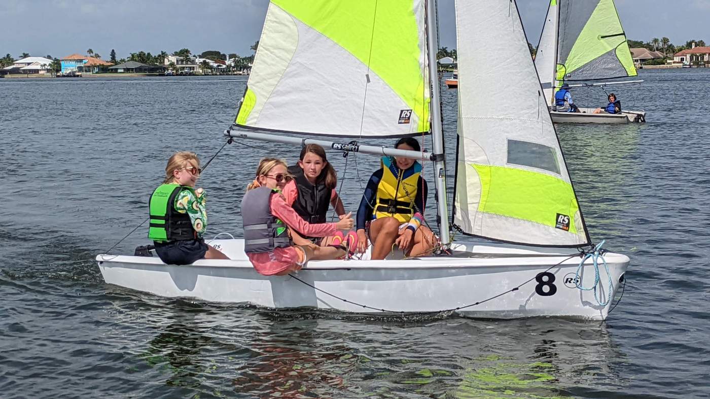 Four girls sailing a boat