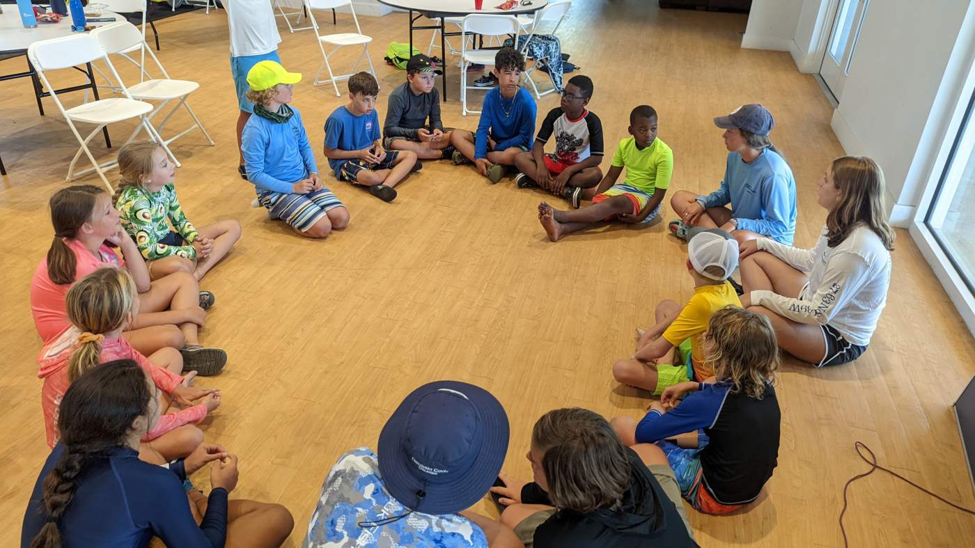 Children seated on the floor in a circle