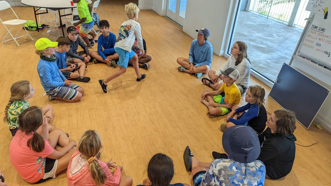 Children seated on the floor in a circle